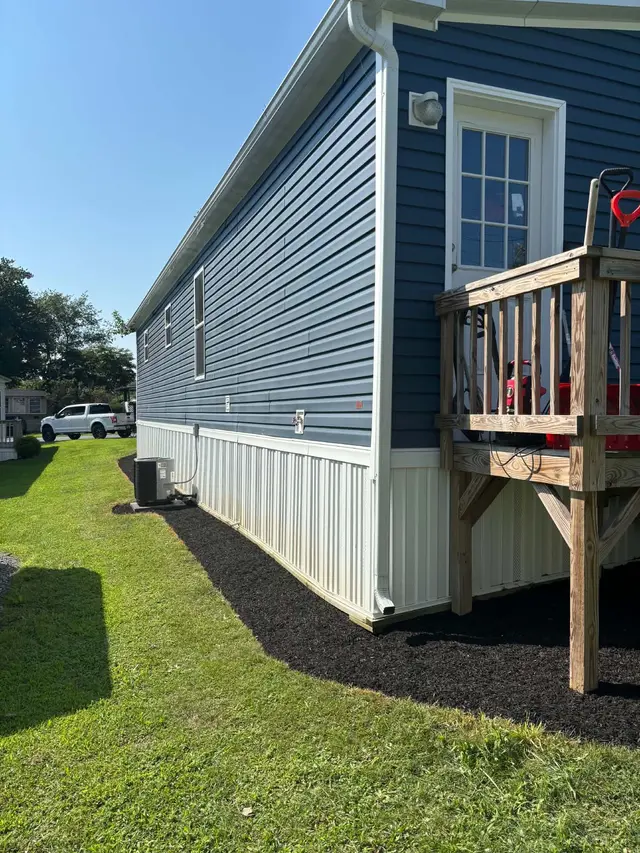 Foundation edge cleared and covered with fresh black mulch