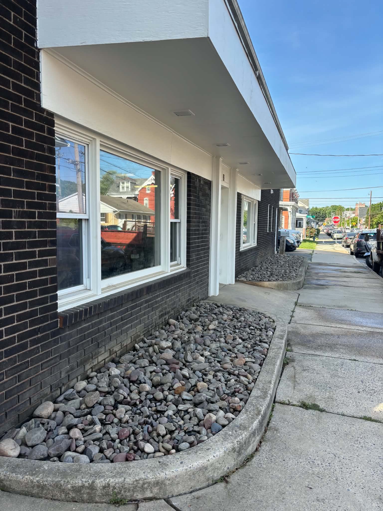 River rock installed in a bed along a brick storefront